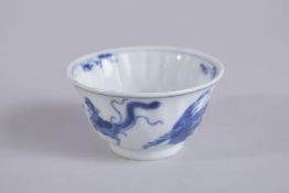 A CHINESE KANGXI PERIOD BLUE AND WHITE PORCELAIN TEA CUP, painted with phoenix, base with mark, 7.