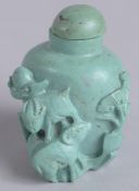 AN EARLY 20TH CENTURY CHINESE CARVED TURQUOISE SNUFF BOTTLE, 4.5cm high.