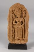 A FINE CAMBODIAN KHMER STYLE PANEL DEPICTING A DEITY, on a wooden stand, 35cm high overall.