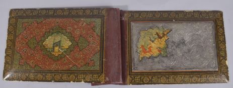 A PERSIAN QAJAR METAL MOUNTED LACQUERED BOOK COVER, with painted miniature depicting figures on