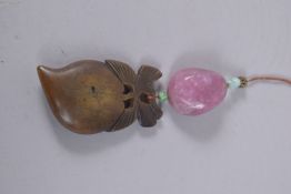 A CHINESE SIGNED CARVED WOOD PENDANT WITH TOURMALINE AND JADE MOUNTS.