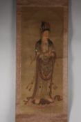 A CHINESE SCROLL PAINTING ON PAPER, depicting Guanyin stood upon a lotus.