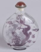 A 19TH CENTURY CHINESE PEKING GLASS SNUFF BOTTLE, with dragons and stylised clouds, 7.5cm high.