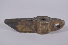 A VERY EARLY ISLAMIC CARVED STONE OIL LAMP, possibly 5th-6th century, 22.5cm long.