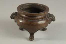 A CHINESE BRONZE TRIPOD CENSER, with lion face handles, the base with character mark, 17cm wide (