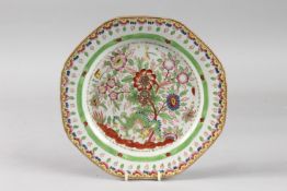 A 19TH CENTURY CHINESE CLOBBERED PORCELAIN PLATE, painted with dragon and flora, 24.5cm wide.