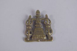 A TIBETAN BRASS PENDANT OR CLOTHING ORNAMENT.