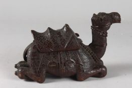 A FINELY CARVED 19TH CENTURY INDIAN WOODEN CAMEL, 20cm long.