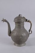 AN EARLY 20TH CENTURY AFGHAN ENGRAVED BRONZE LIDDED EWER, with calligraphic roundel to each side,