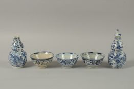 THREE CHINESE BLUE AND WHITE BOWLS, together with a pair of lidded gourd vases, (af).