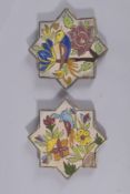 TWO PERSIAN GLAZED POTTERY STAR TILES, post Qajar, painted with birds and flora, 17cm wide.