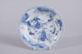 A CHINESE KANGXI PERIOD BLUE AND WHITE PORCELAIN SAUCER, painted with a hunting scene, mark to base,