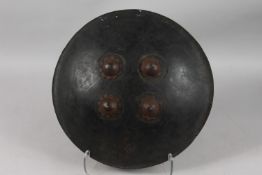 AN 18TH CENTURY INDIAN SHIELD, with four steel bosses, 41.5cm diameter.