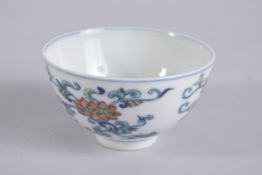 A CHINESE DOUCAI PORCELAIN BOWL, painted with floral motifs, base with six-character mark, 9cm