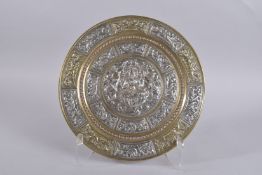 A FINE LARGE SOUTH INDIAN TANJORE SILVER AND COPPER OVERLAID BRASS CHARGER, 33cm diameter.