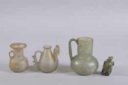 A COLLECTION OF FOUR POSSIBLY ROMAN OR EARLY ISLAMIC GLASS VESSELS, (4).