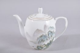 A CHINESE REPUBLIC PORCELAIN TEAPOT, painted with a mountainous landscape and inscription, base with