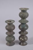 TWO 13TH CENTURY SELJUK BRONZE CANDLESTICK BASES, 21cm high and 14cm high, (2).