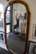 A large upright wall mirror with Boulle style frame.