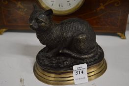 A cast bronze model of a seated cat.