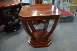 An Art Deco style rosewood stained square shaped occasional table on curving supports.