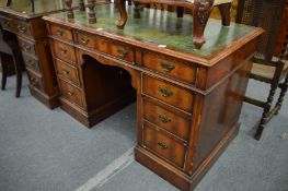 A Georgian style walnut one piece pedestal desk with green leather inset top.
