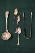 A pair of silver sugar tongs, Exeter 1852, a silver ladle, London 1816 and three silver teaspoons.
