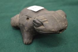 A Peruvian pottery frog whistle.