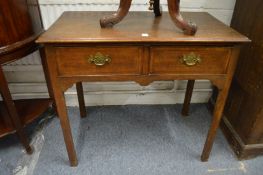 An oak two drawer side table.