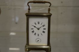 A brass carriage clock with alarm.