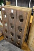 A folding double sided wine rack.