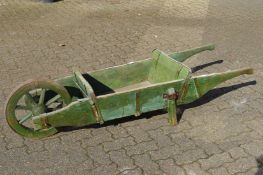 A 19th century green painted wooden wheelbarrow.