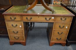 A reproduction yew wood pedestal desk.