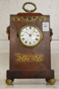 A Regency brass inlaid mahogany mantel clock with watch movement.