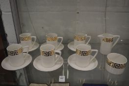 A set of six Portmeirion coffee cups and saucers, white ground with gilt Greek key border,