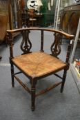 A rush seated corner armchair.