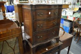 A Georgian style mahogany serpentine fronted three drawer chest.