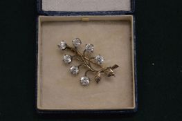 A decorative gem set leaf shaped brooch.