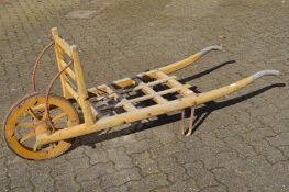 A 19th century yellow painted wooden porters trolley.