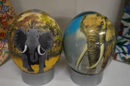 Two emu eggs painted with elephants.