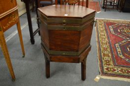 A George III mahogany and brass bound hexagonal shaped cellarette on stand.