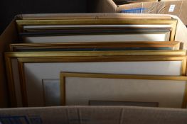 A box of assorted paintings and prints.