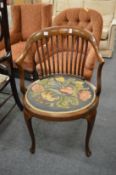 An Edwardian inlaid mahogany armchair with needlework upholstered seat.