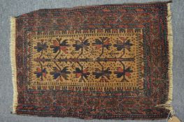 A small Persian rug, 70cm x 50cm.