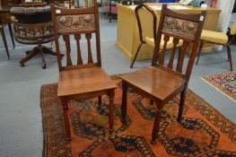 A pair of Art Nouveau walnut hall chairs, possibly by Shapland & Petter, the backs inset with an