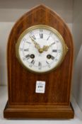 An Edwardian lancet shaped mahogany cased mantel clock.