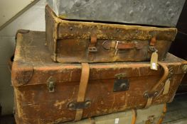Two large canvas covered trunks.
