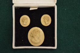 Three small portrait cameos.