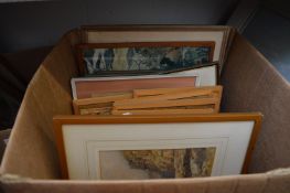 A box of various paintings and prints.