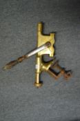A bar mounted brass cork screw.